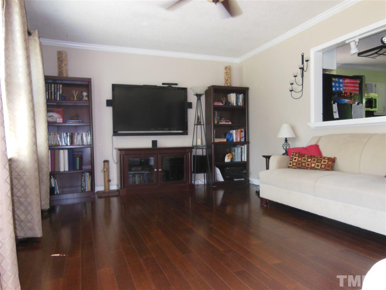 1125 Marlborough Road Raleigh, NC 27610 - Photo 5 of 23 a living room with furniture and a flat screen tv
