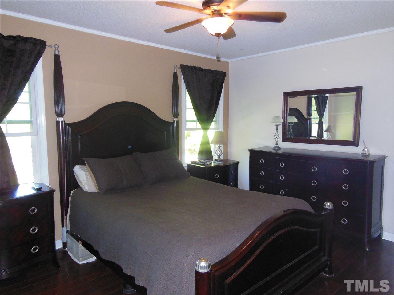 1125 Marlborough Road Raleigh, NC 27610 - Photo 9 of 23 a bedroom with a bed and a chandelier