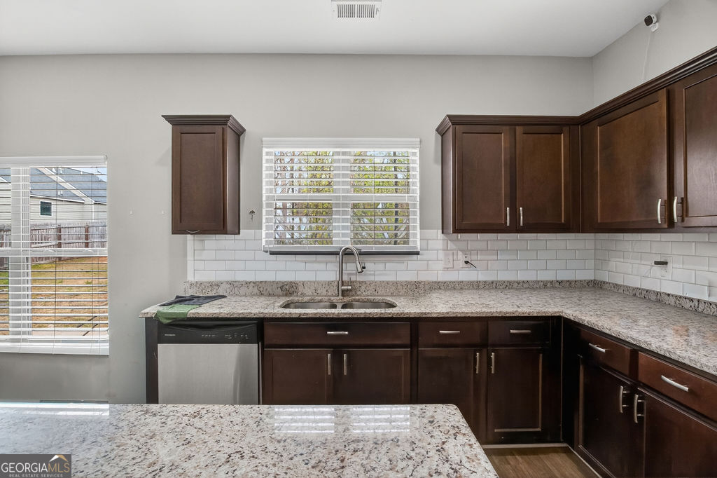 3495 Zaks Way Bethlehem, GA 30620 - Photo 11 of 40 a kitchen with granite countertop cabinets sink and window