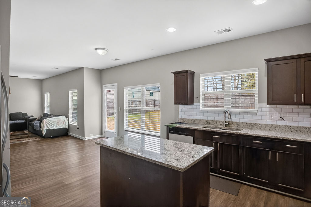 3495 Zaks Way Bethlehem, GA 30620 - Photo 12 of 40 a kitchen with granite countertop a sink and a stove