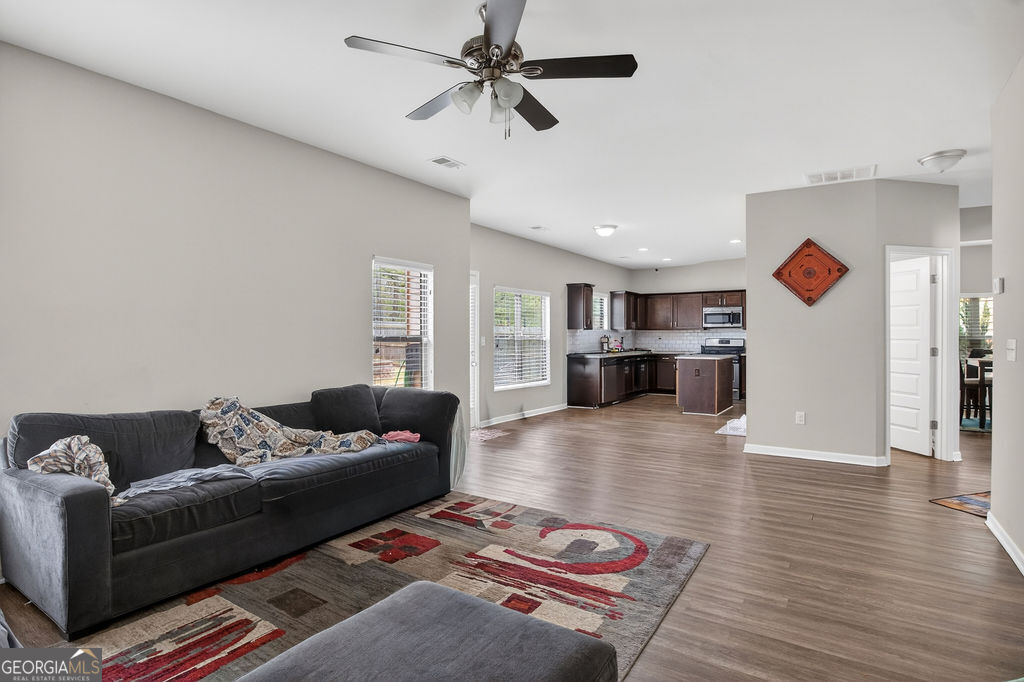 3495 Zaks Way Bethlehem, GA 30620 - Photo 17 of 40 a living room with furniture and wooden floor