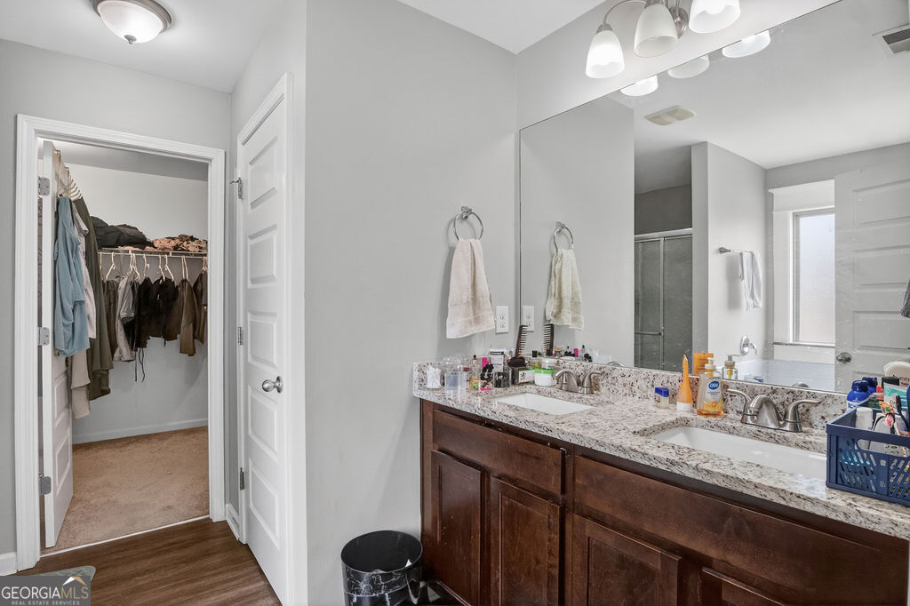 3495 Zaks Way Bethlehem, GA 30620 - Photo 23 of 40 a bathroom with a sink double vanity and a mirror