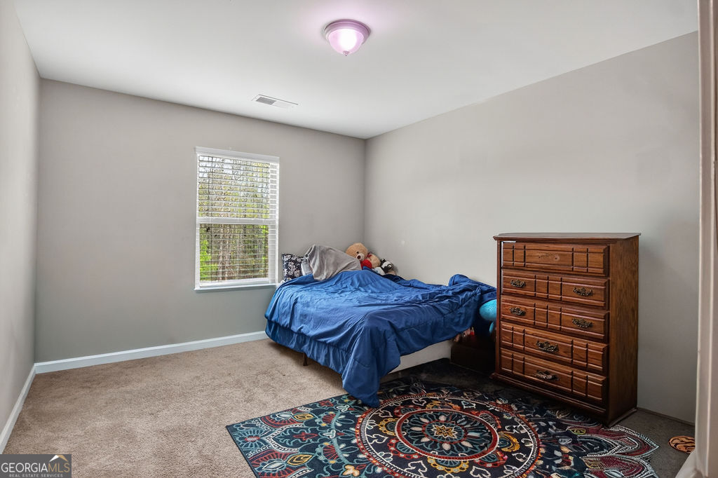 3495 Zaks Way Bethlehem, GA 30620 - Photo 31 of 40 a bedroom with a bed and a window