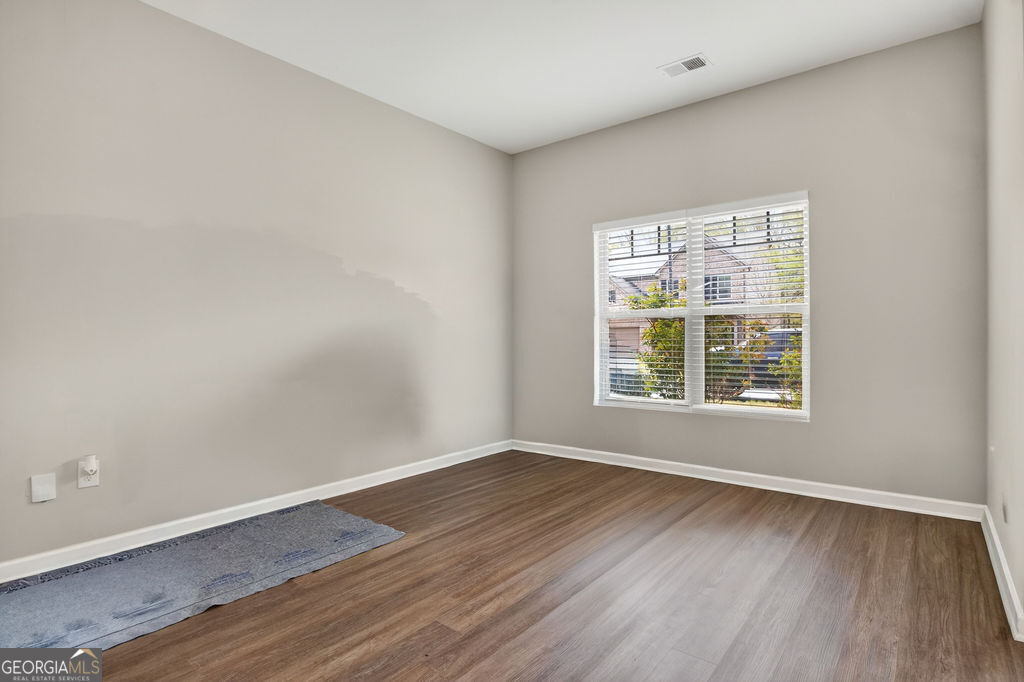 3495 Zaks Way Bethlehem, GA 30620 - Photo 7 of 40 an empty room with wooden floor and windows