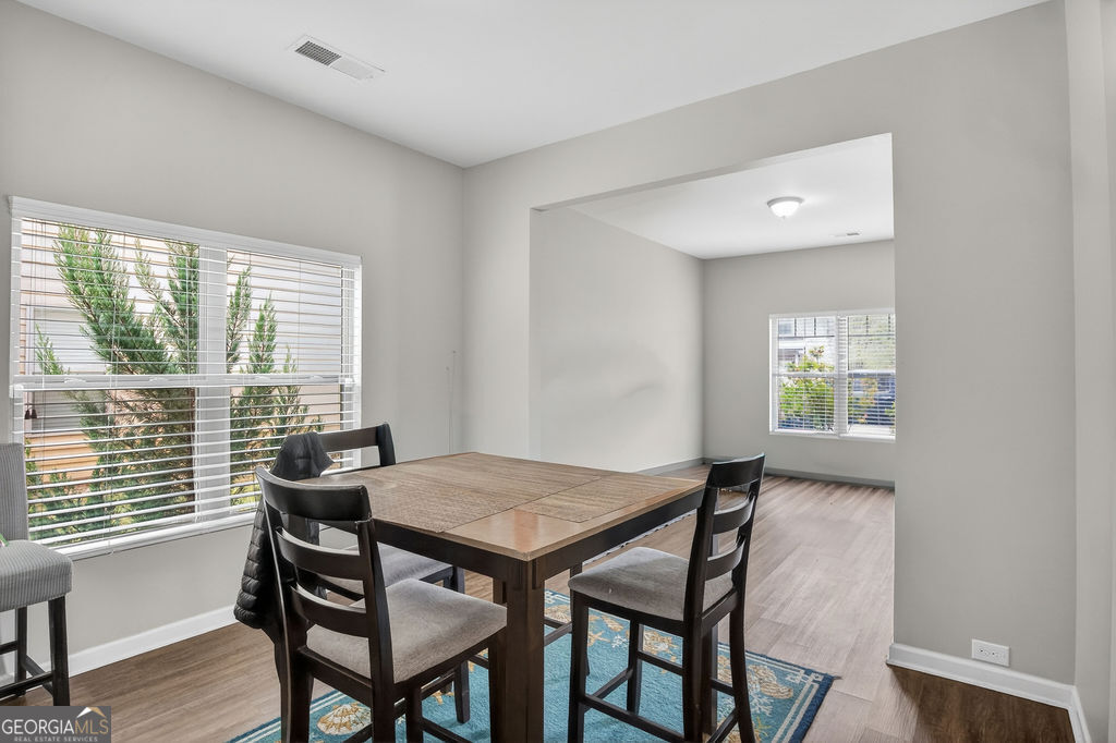 3495 Zaks Way Bethlehem, GA 30620 - Photo 8 of 40 a view of a dining room with furniture and wooden floor