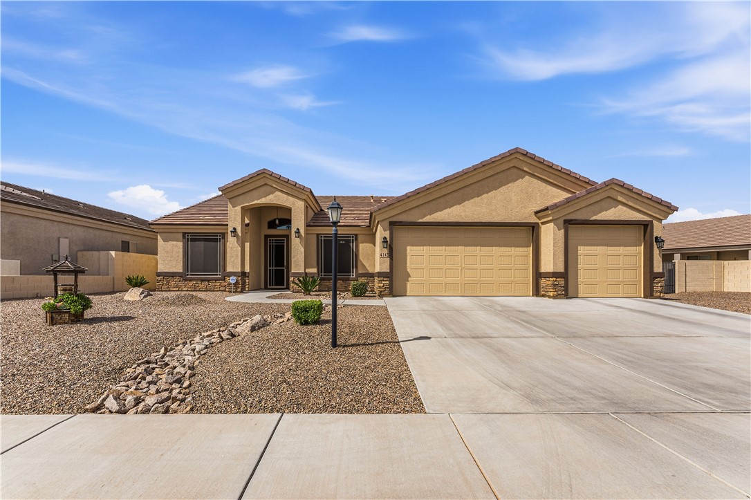 4143 North Stampede Road Kingman, AZ 86401 - Photo 6 of 42 Stucco exterior featuring a tile roof, stone accents, and a desert-style front yard