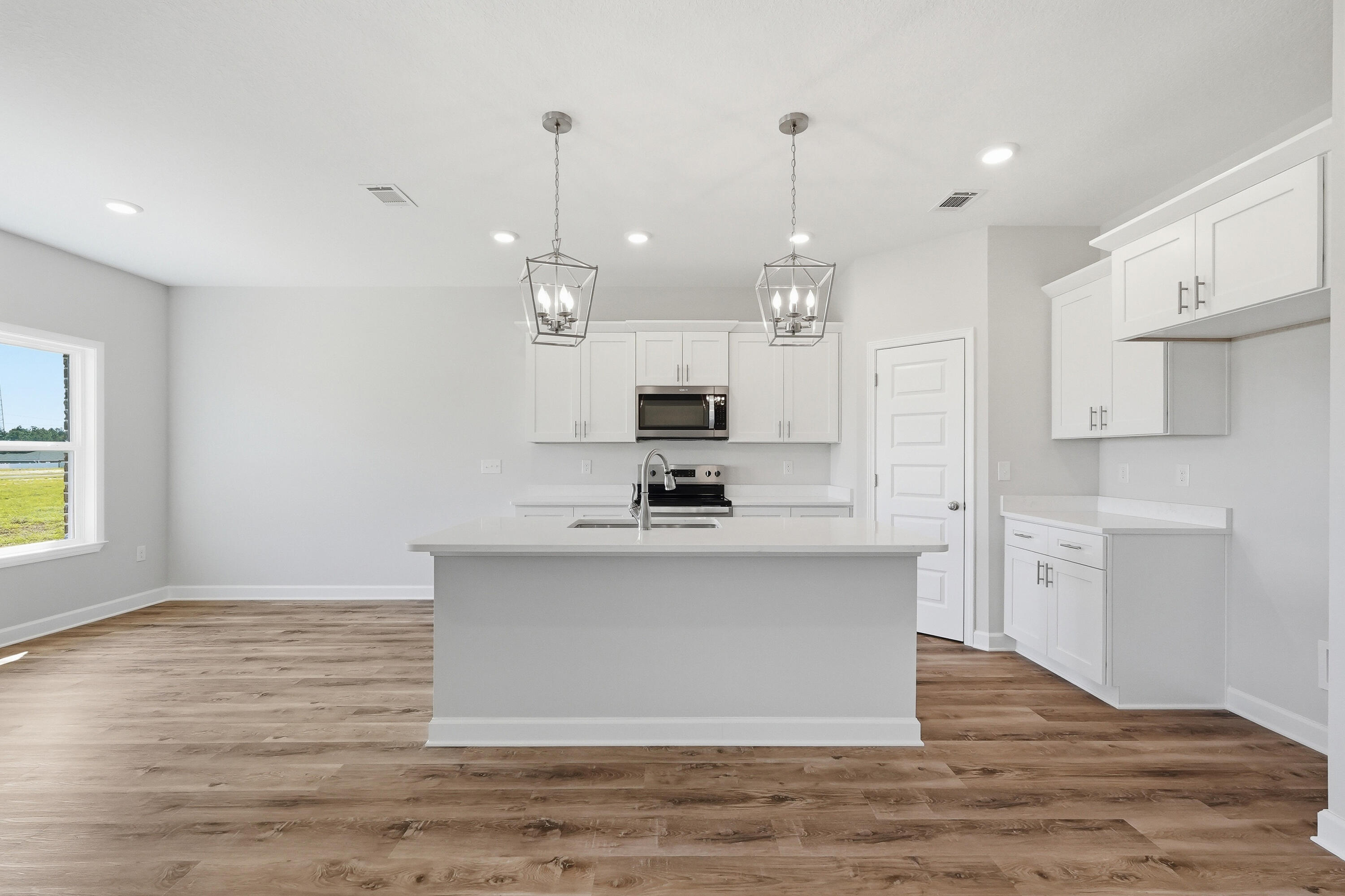 6114 Mildreds Way Crestview, FL 32539 - Photo 7 of 24 a view of a kitchen with kitchen island a sink stainless steel appliances and cabinets