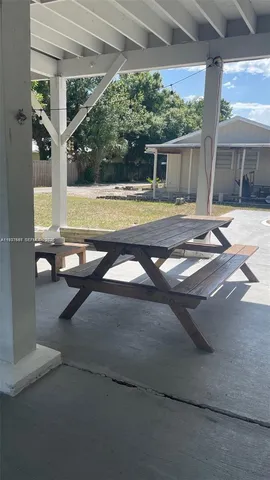 a view of swimming pool with outdoor seating and yard in back