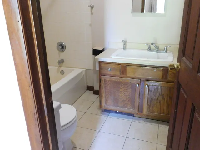 a bathroom with a sink a toilet and bathtub