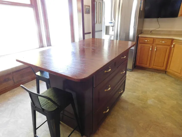 a view of a kitchen area with furniture and wooden floor
