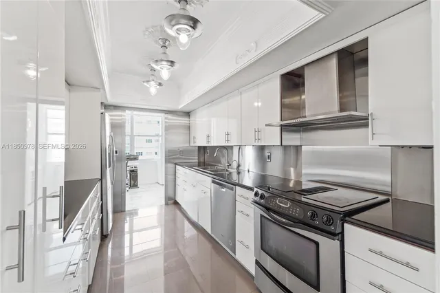 a kitchen with stainless steel appliances granite countertop a stove and a refrigerator