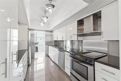 a kitchen with stainless steel appliances granite countertop a stove and a refrigerator