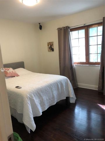 a living room with furniture rug and a window