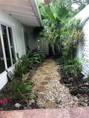 a view of a house with potted plants