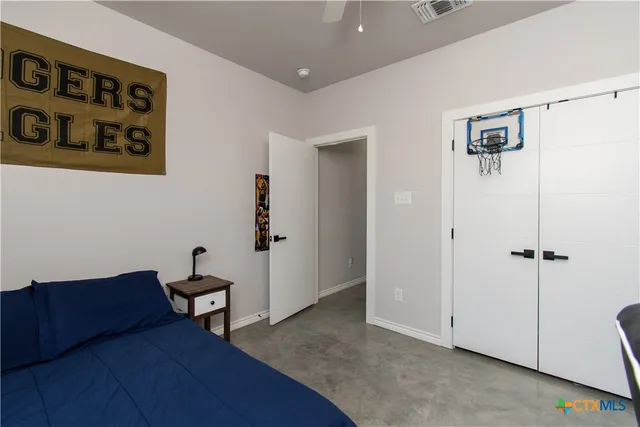 a living room with furniture and a baby crib