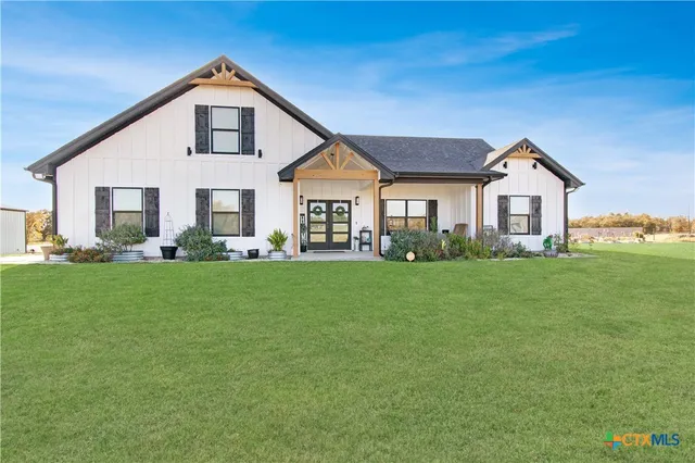 a front view of house with yard and green space