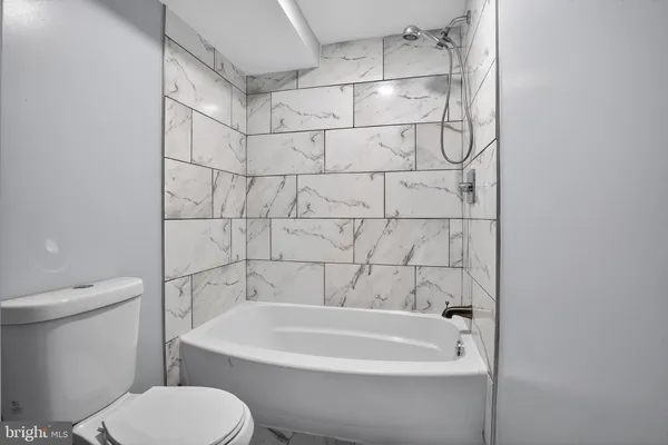 a bathroom with a bathtub and a toilet