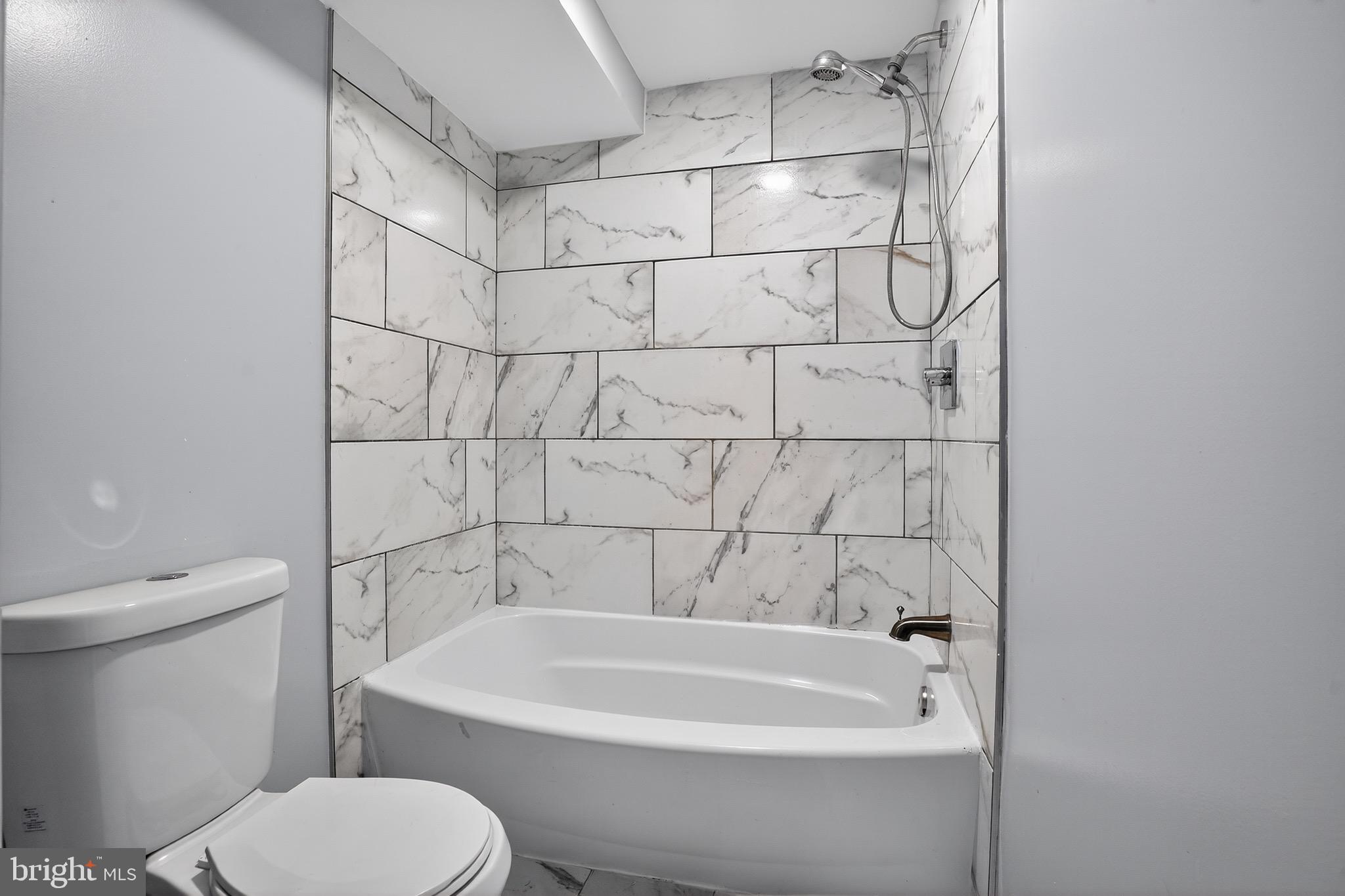a bathroom with a bathtub and a toilet