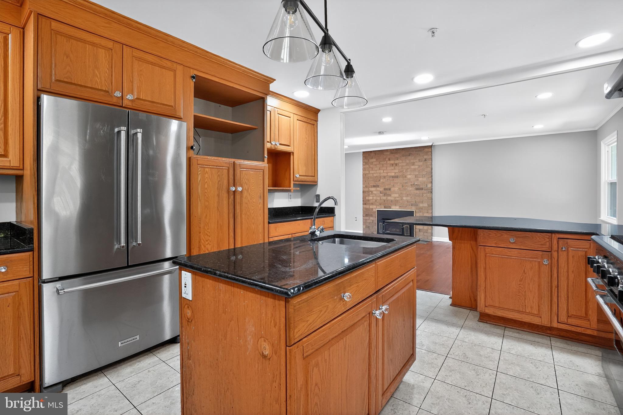 11308 Chantilly Lane Bowie, MD 20721 - Photo 15 of 30 a kitchen with stainless steel appliances granite countertop a refrigerator a sink and a stove