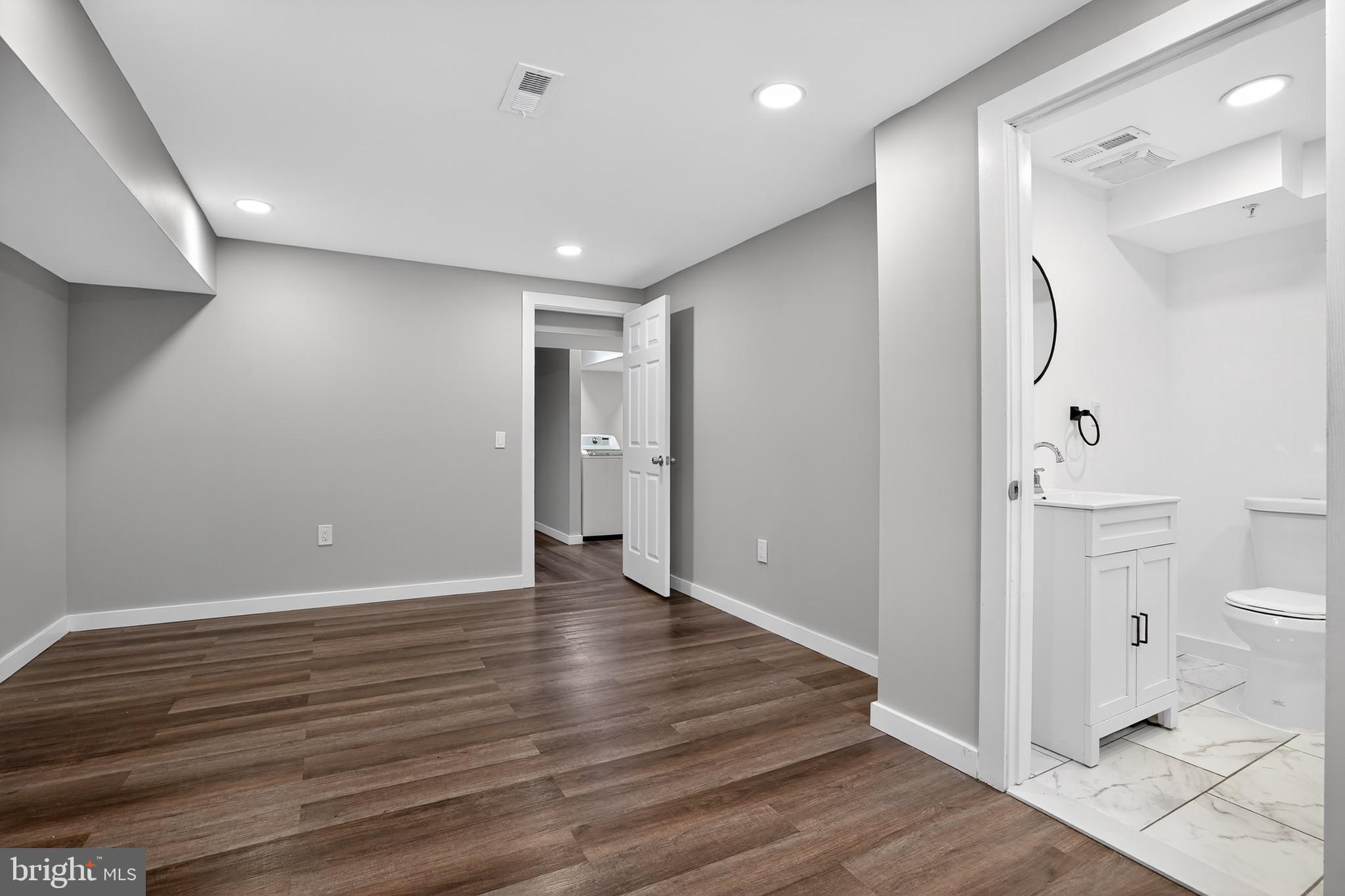 11308 Chantilly Lane Bowie, MD 20721 - Photo 2 of 30 a view of a bathroom with wooden floor and a toilet