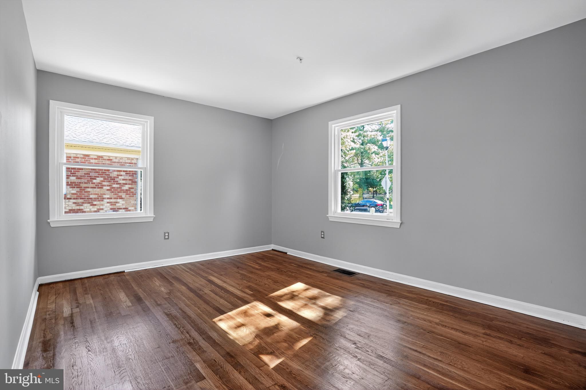 11308 Chantilly Lane Bowie, MD 20721 - Photo 21 of 30 a view of an empty room with wooden floor and a window