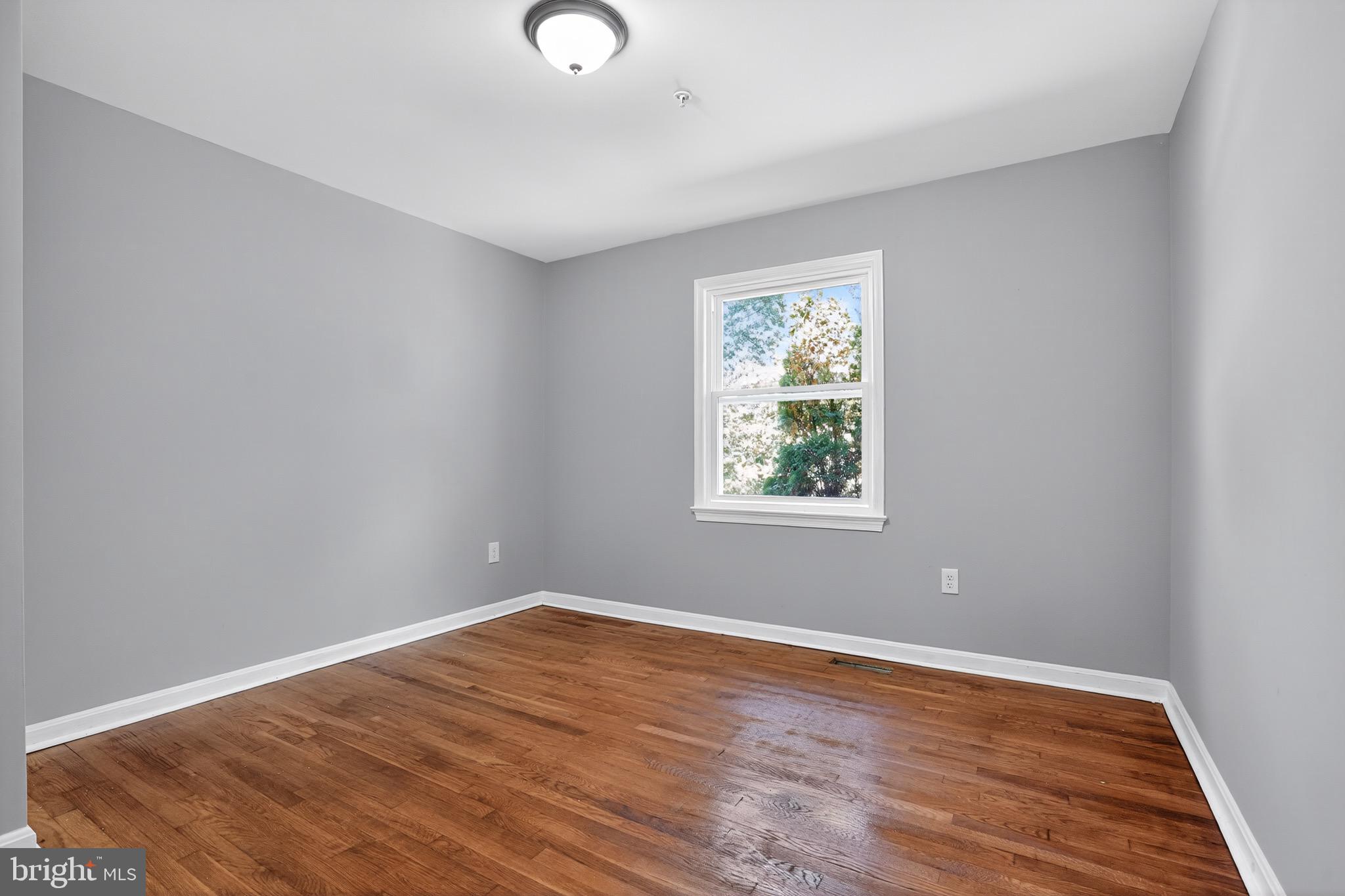 11308 Chantilly Lane Bowie, MD 20721 - Photo 23 of 30 an empty room with wooden floor and windows