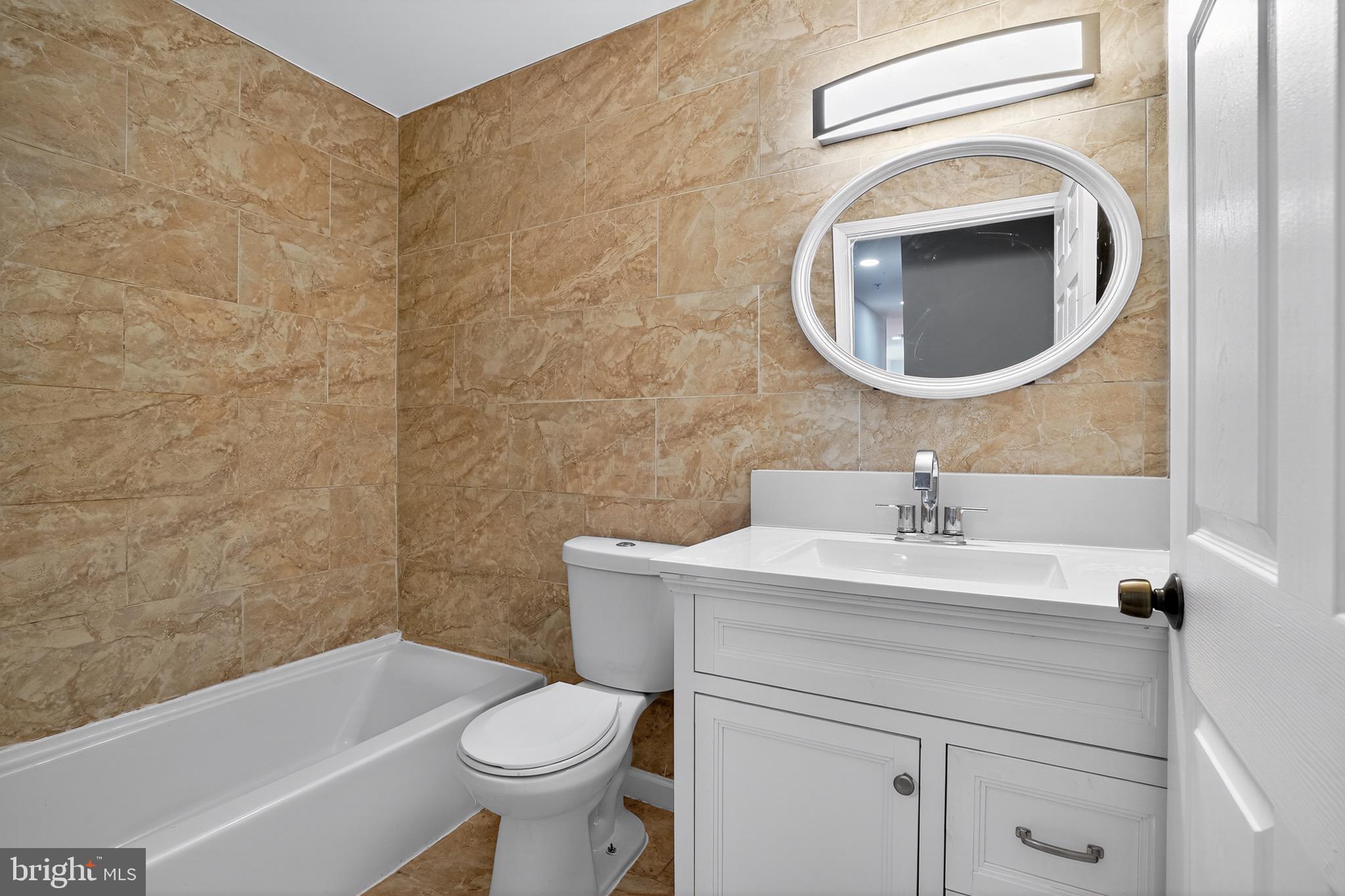 11308 Chantilly Lane Bowie, MD 20721 - Photo 4 of 30 a bathroom with a sink a toilet and a mirror