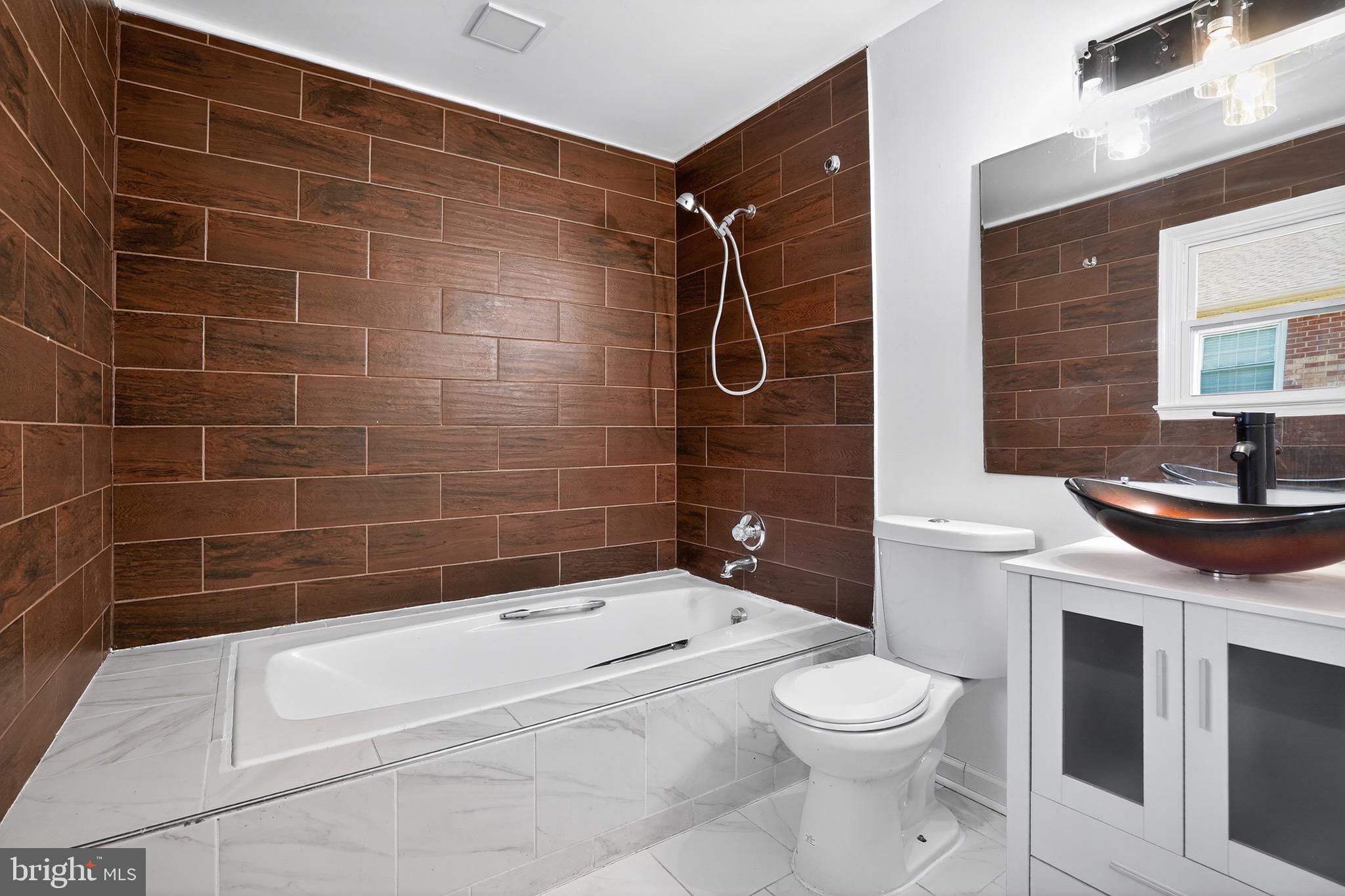 11308 Chantilly Lane Bowie, MD 20721 - Photo 5 of 30 a bathroom with a sink a toilet and shower