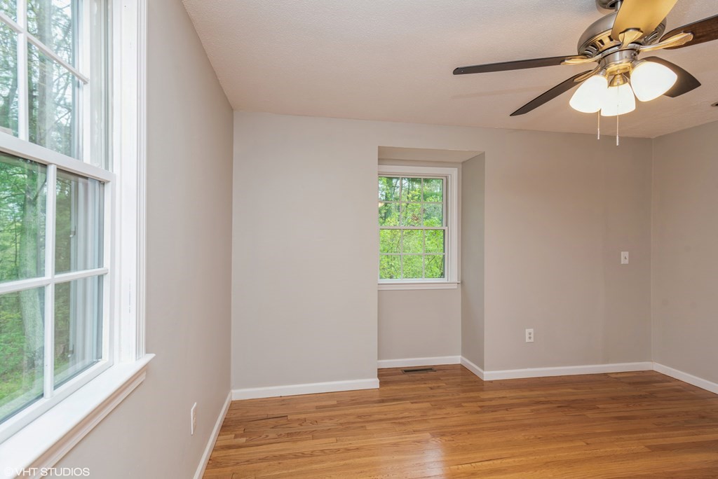106 Martin Farms Road Hampden, MA 01036 - Photo 11 of 34 a view of an empty room with window and wooden floor