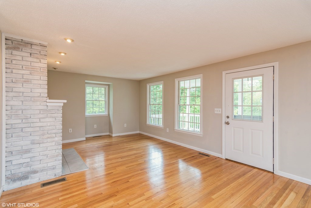 106 Martin Farms Road Hampden, MA 01036 - Photo 4 of 34 a view of an empty room with a window and wooden floor