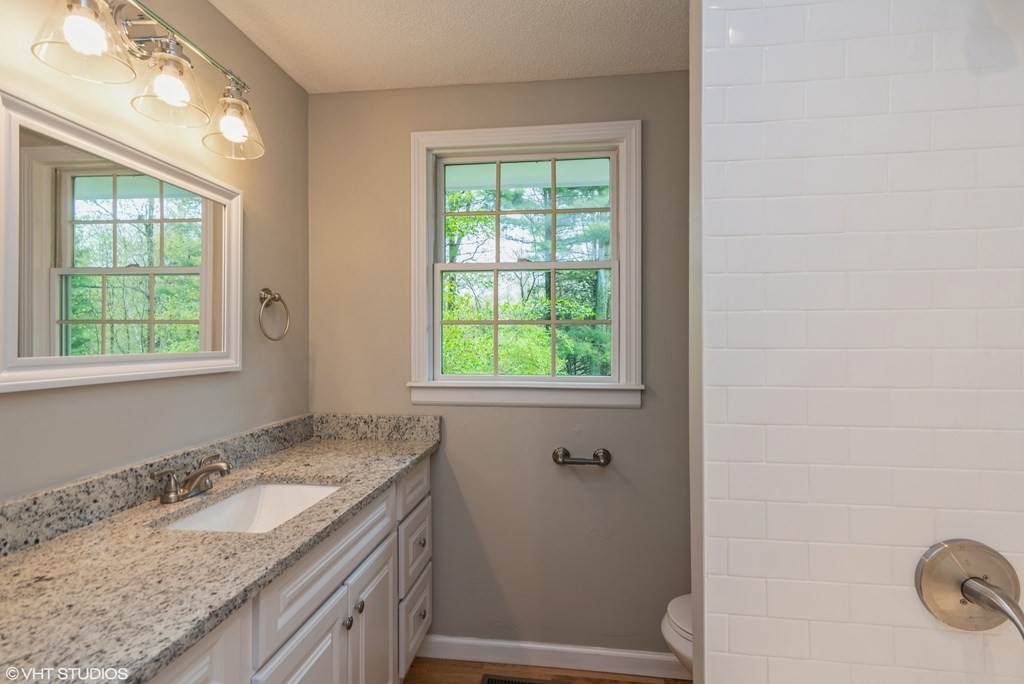 106 Martin Farms Road Hampden, MA 01036 - Photo 9 of 34 a bathroom with a granite countertop sink and a window