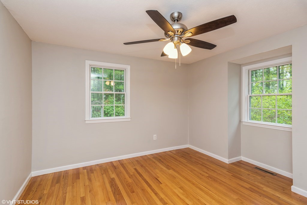 106 Martin Farms Road Hampden, MA 01036 - Photo 10 of 34 a view of empty room with wooden floor and fan