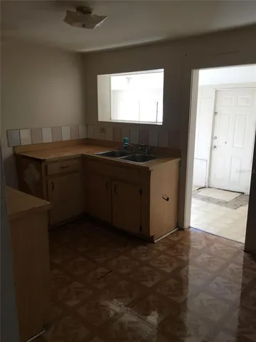 a kitchen with granite countertop a sink and a stove