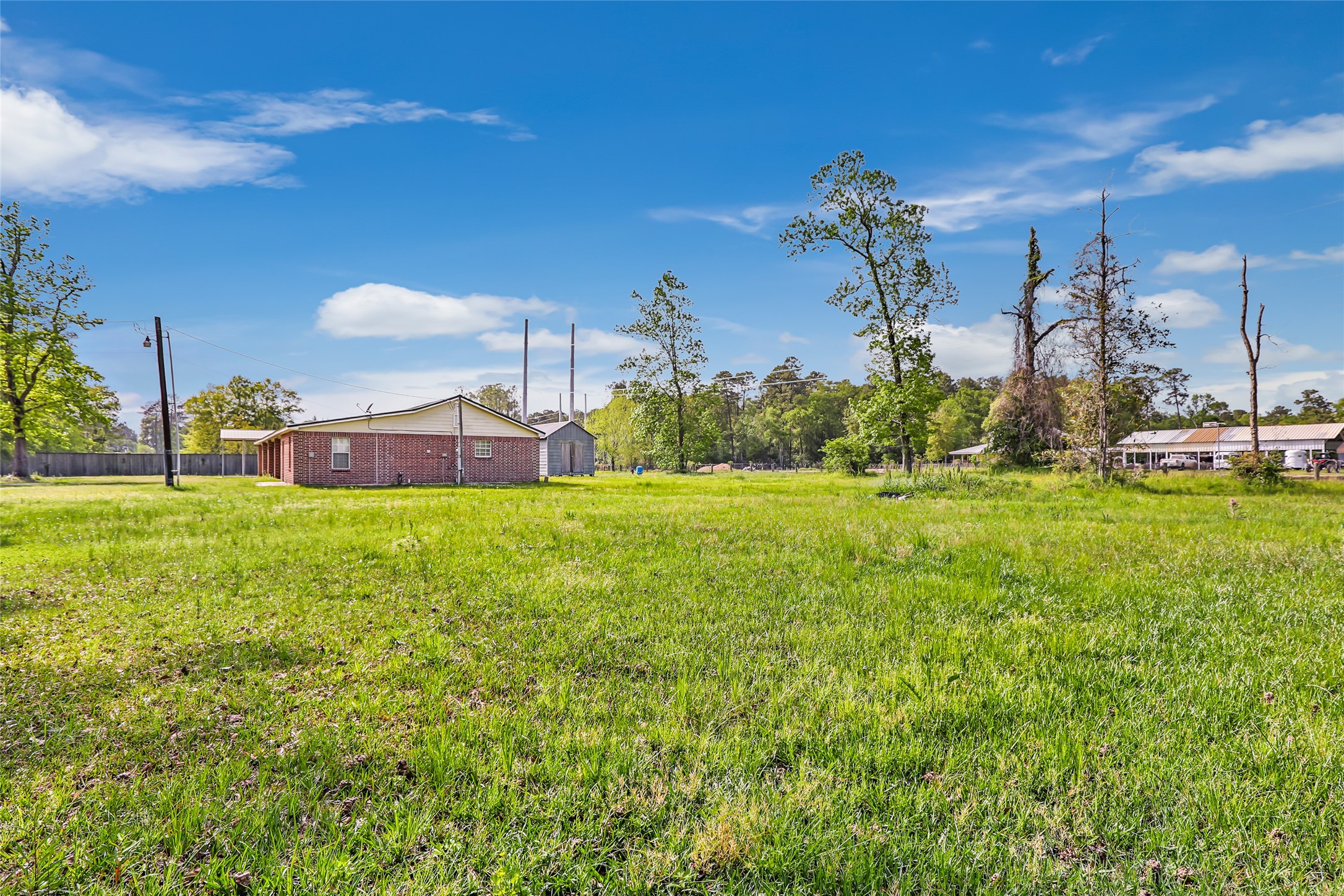 27311 Kingport Drive Splendora, TX 77372 - Photo 11 of 26 a view of a house with a big yard and large trees