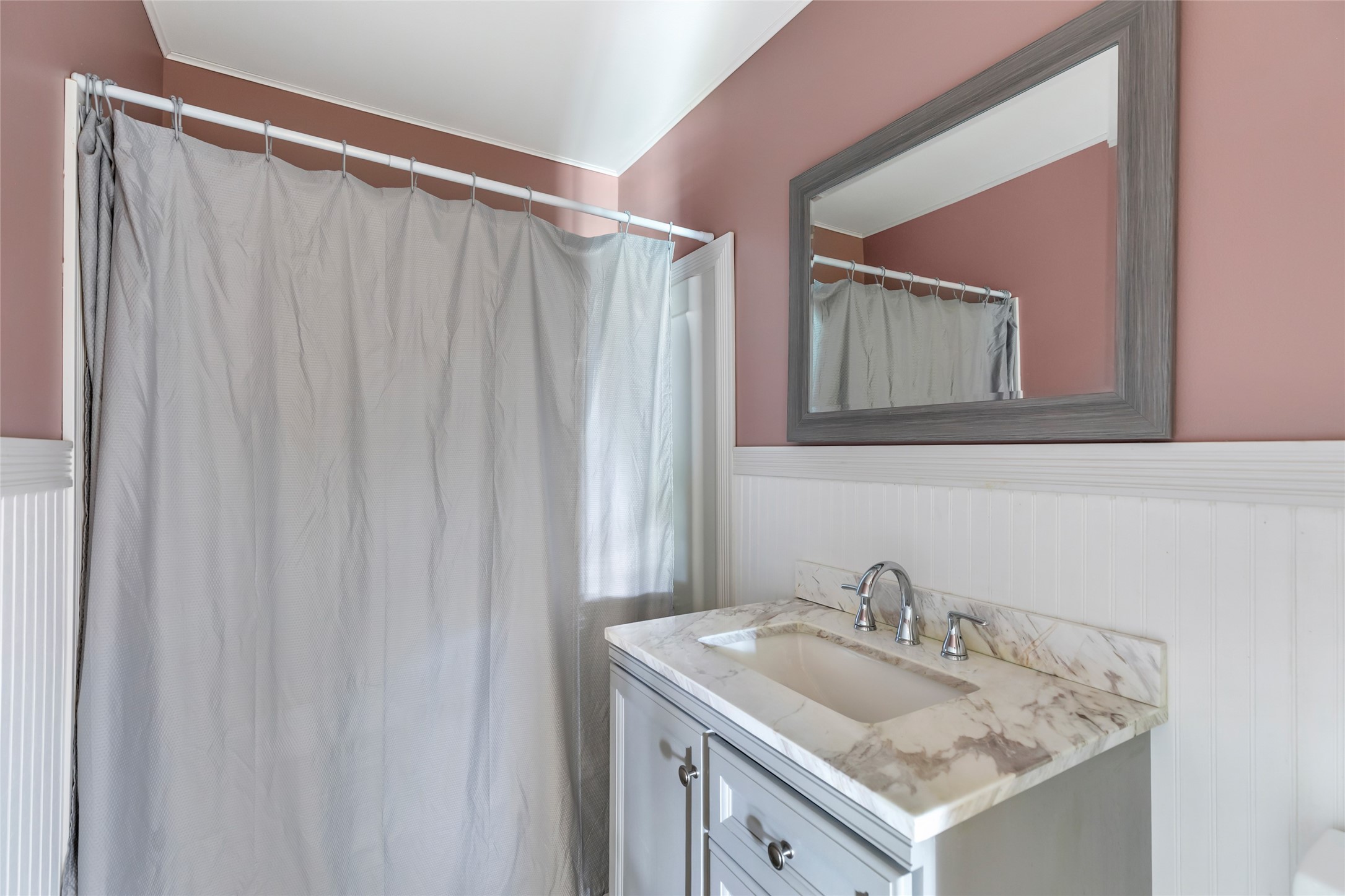 27311 Kingport Drive Splendora, TX 77372 - Photo 19 of 26 a bathroom with a sink and a mirror