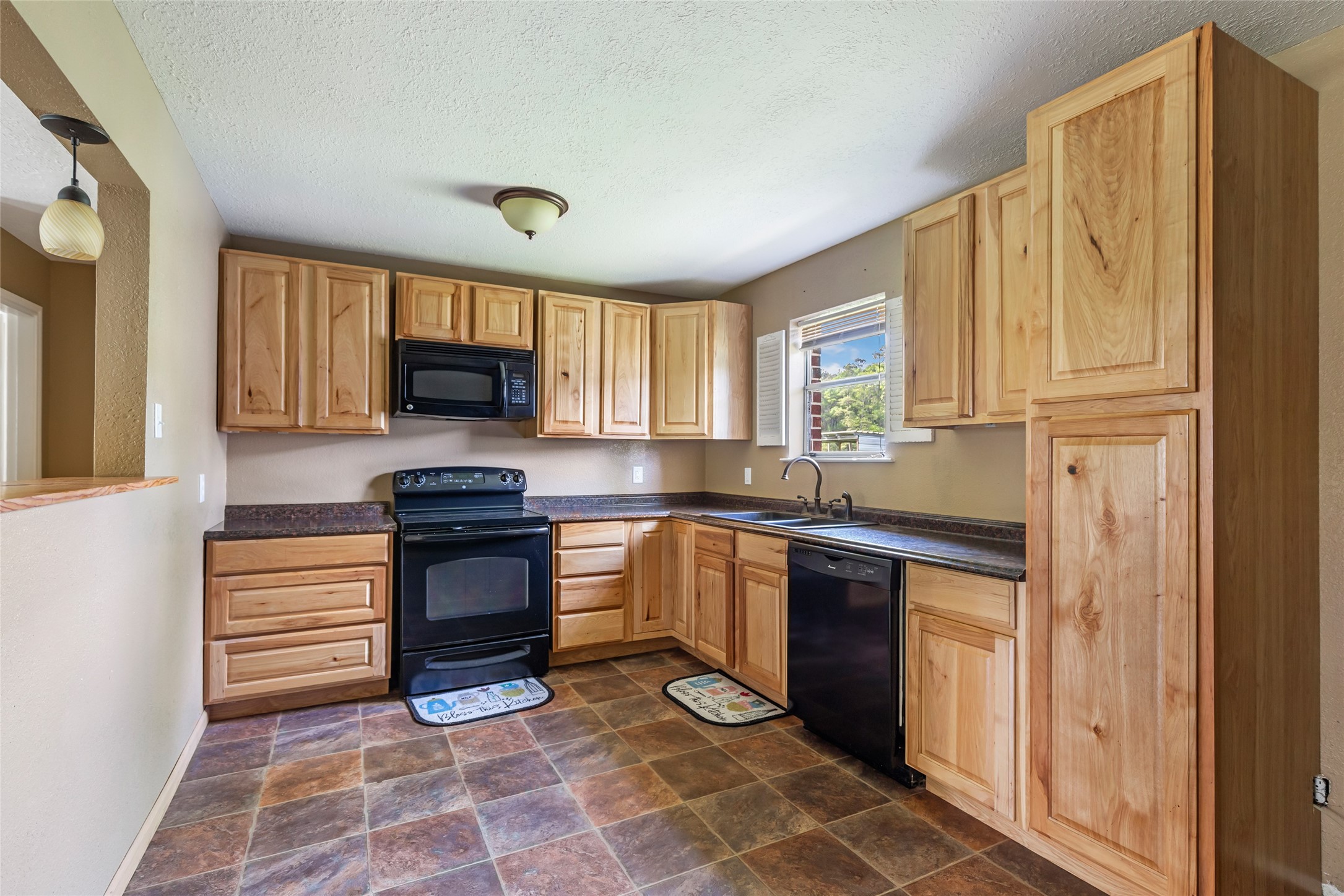 27311 Kingport Drive Splendora, TX 77372 - Photo 20 of 26 a kitchen with stainless steel appliances granite countertop a refrigerator stove top oven and sink