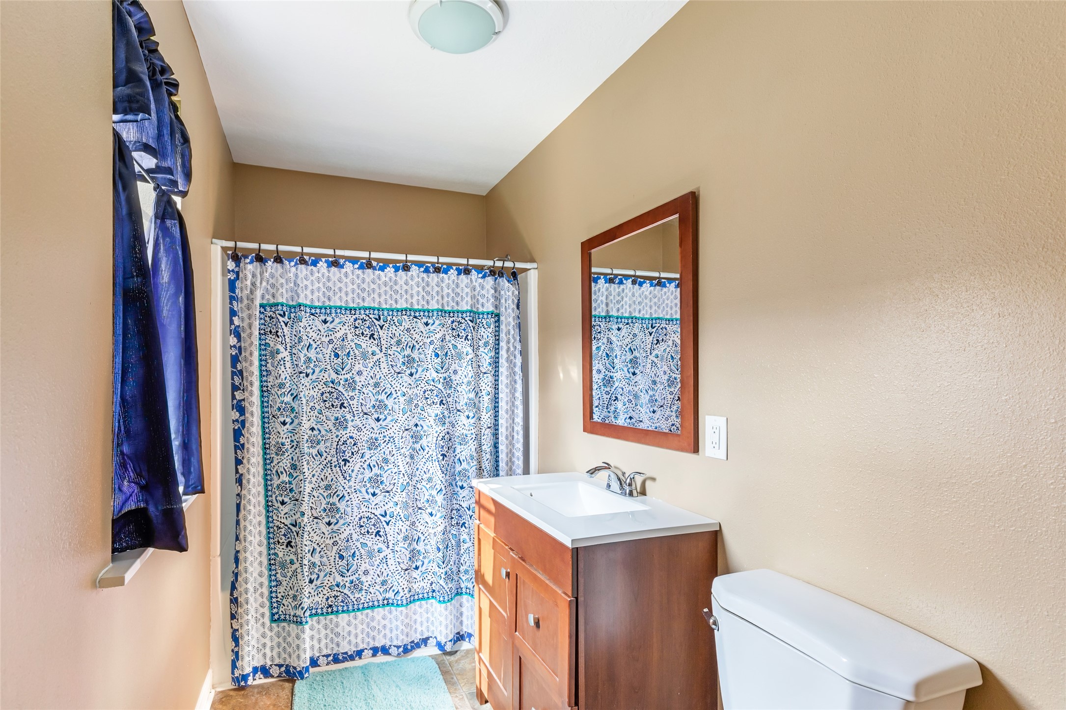 27311 Kingport Drive Splendora, TX 77372 - Photo 26 of 26 a bathroom with a sink a toilet and shower curtain