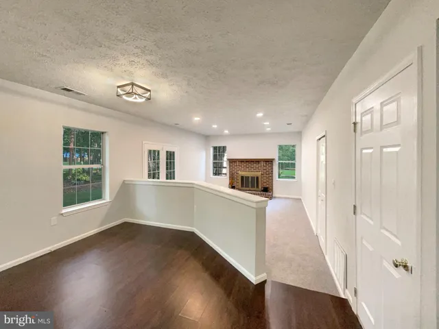 a view of kitchen and hall with wooden floor