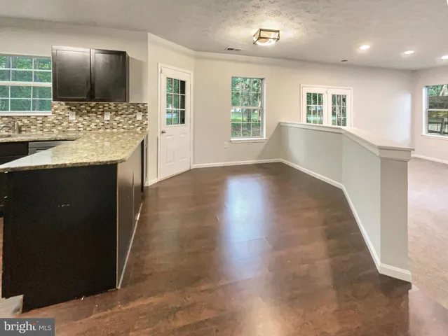 a view of kitchen with kitchen island sink and refrigerator
