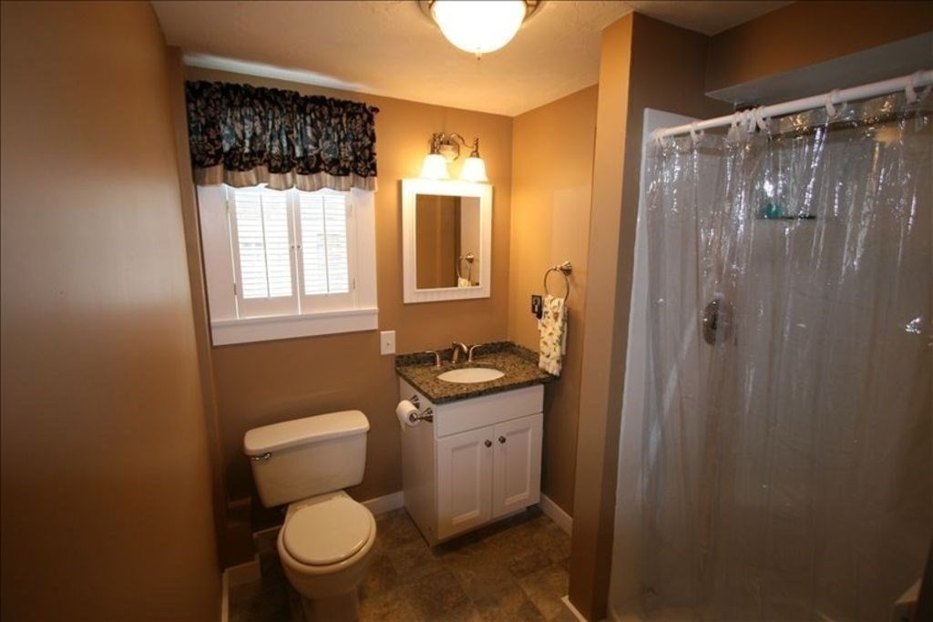 11 Hughes Road, Unit 1 Truro, MA 02666 - Photo 9 of 35 a bathroom with a toilet a sink and a shower