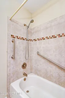 a bathroom with a tub and a shower