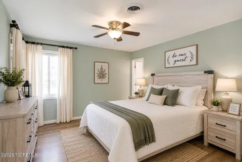 a bedroom with a large bed and a chandelier