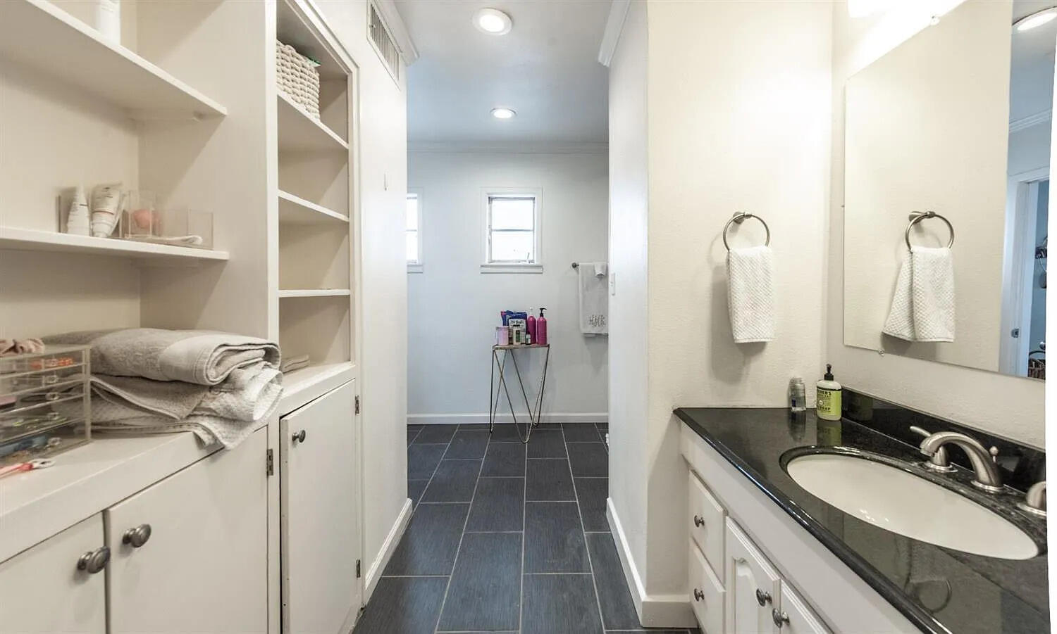 3105 29th Street Lubbock, TX 79410 - Photo 16 of 18 a en suite bathroom with a double vanity sink a mirror and a shower