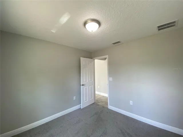 an empty room with closet area