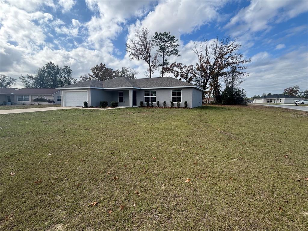 15298 Southwest 43rd Court Ocala, FL 34473 - Photo 2 of 26 a front view of a house with a garden