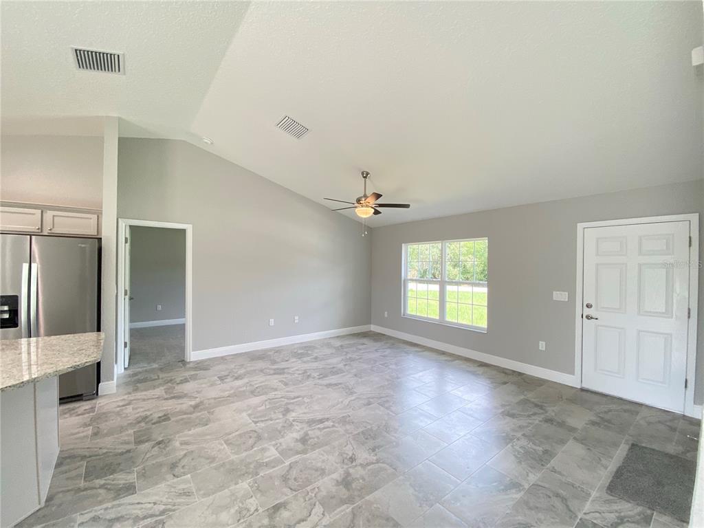 15298 Southwest 43rd Court Ocala, FL 34473 - Photo 3 of 26 an empty room with windows and cabinet