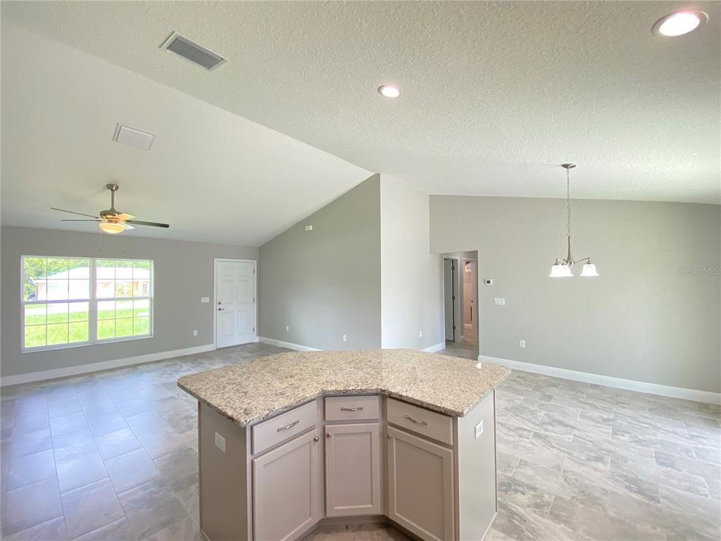 15298 Southwest 43rd Court Ocala, FL 34473 - Photo 8 of 26 a kitchen with a sink and chandelier
