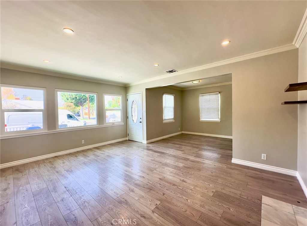 7454 Gaviota Avenue Van Nuys, CA 91406 - Photo 4 of 11 an empty room with wooden floor and windows