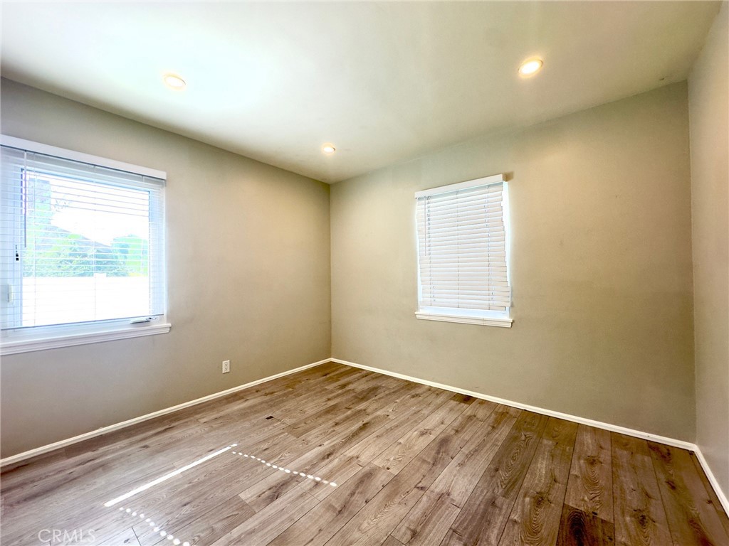 7454 Gaviota Avenue Van Nuys, CA 91406 - Photo 10 of 11 a view of an empty room with wooden floor and a window