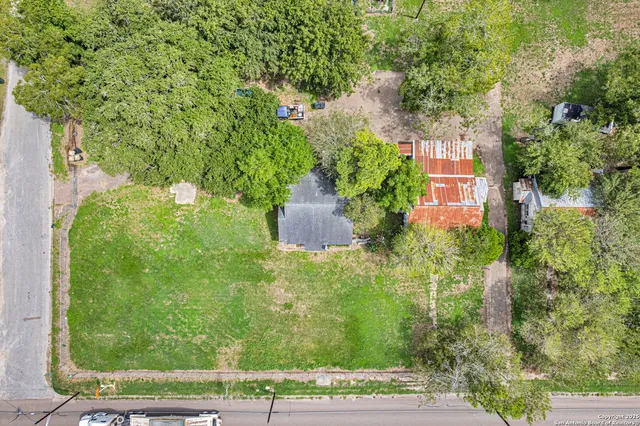an aerial view of a house with yard